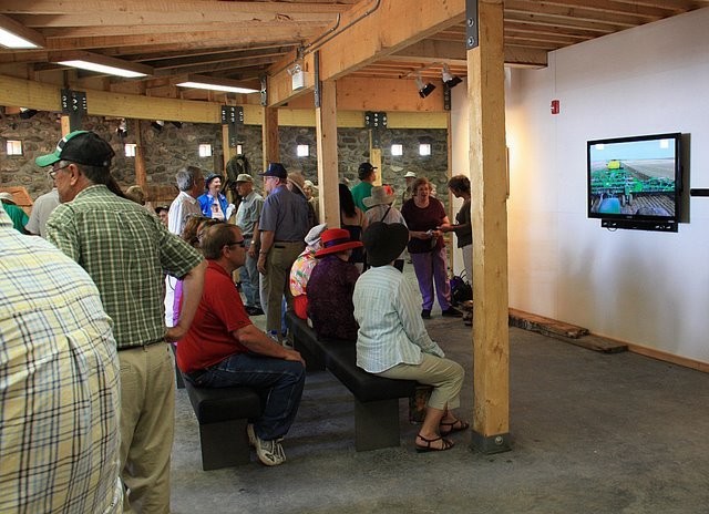 Inside the Bell Barn Interpretive Centre, visitors view the video that tells the story of the Bell Farm and of the reconstruction project. 