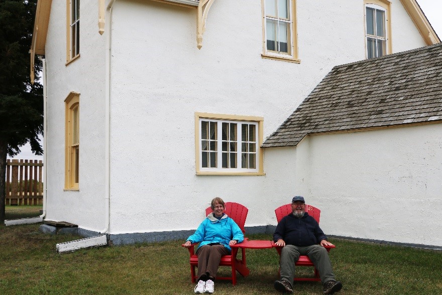 Visitors to Fort Battleford can enjoy the view from the Parks Canada's red chairs