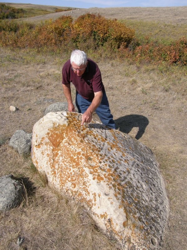 The largest petroglyph is a triangular-shaped rock facing due east. Dozens of circular cupules have also been carved. 